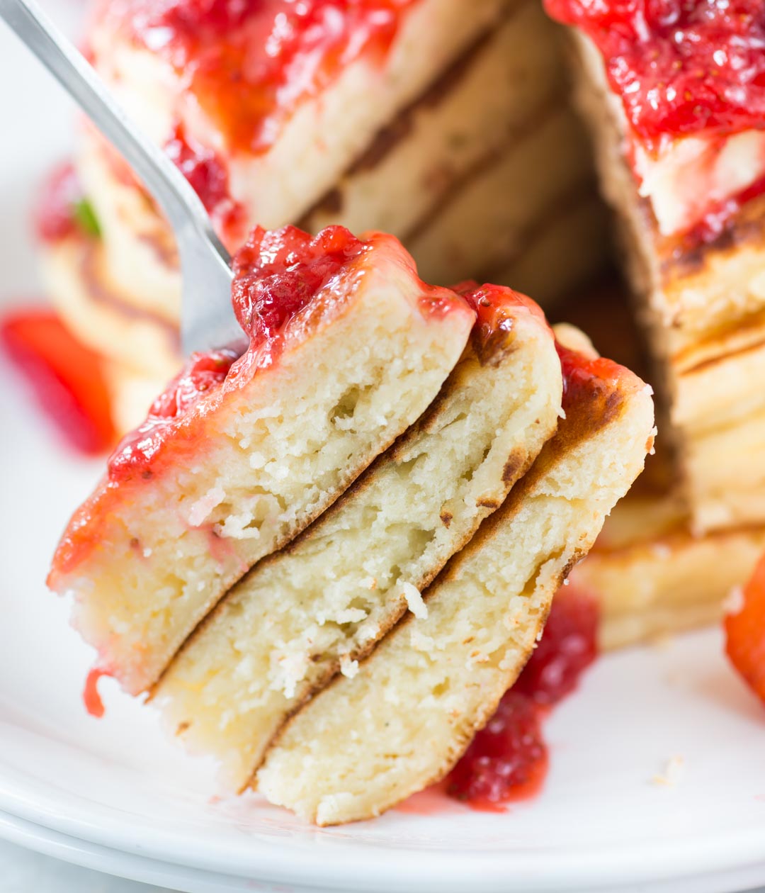 Slice of ricotta pancakes with strawberry topping