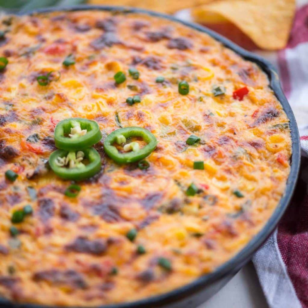 Cheesy mexican corn dip made in a cast iron pan