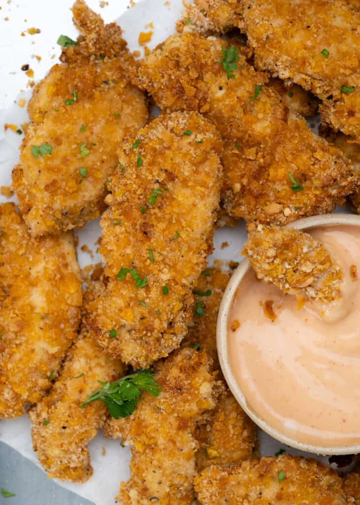 Boneless chicken tenders are coated with an easy 2 ingredients cornflakes coating.