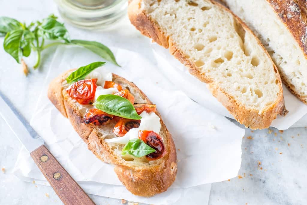 Bruschetta of no-knead bread, roasted tomatoes, fresh basil and mozzarella