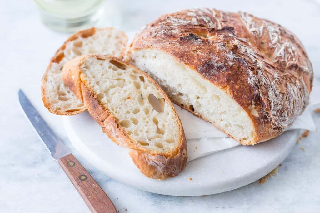 Slice of no-kead rustic white bread showing beautiful air-pockets.