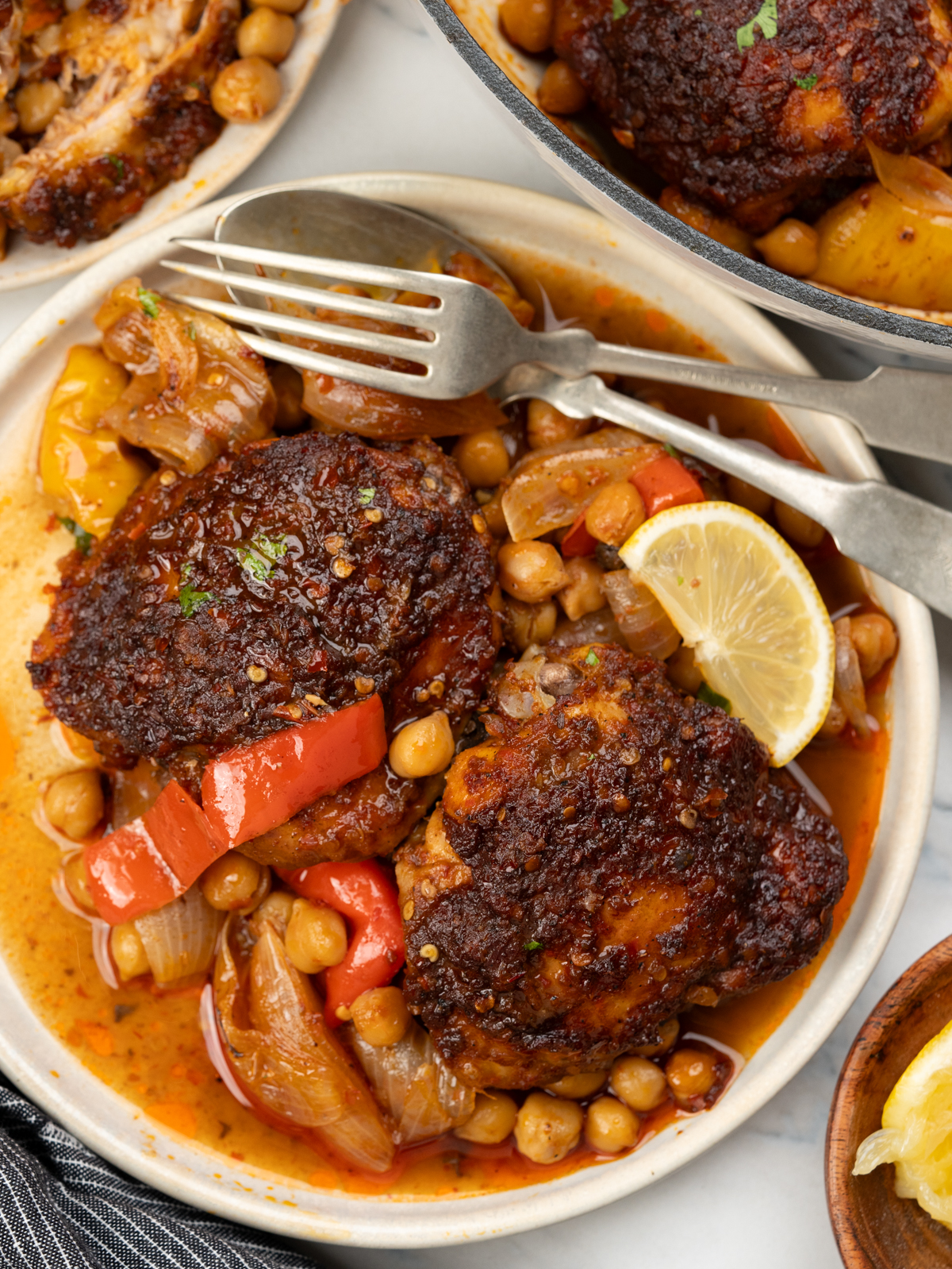 Baked Harissa chicken thighs with chickpeas, onion and pepeprs