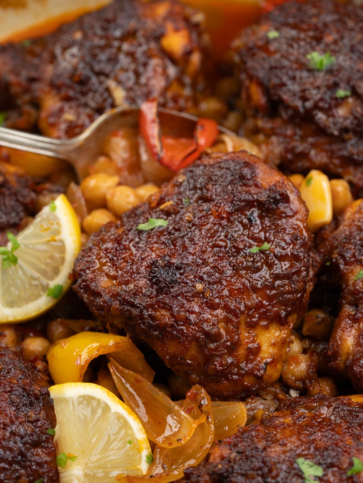 Baked Harissa chicken thighs with chickpeas, onion and pepeprs