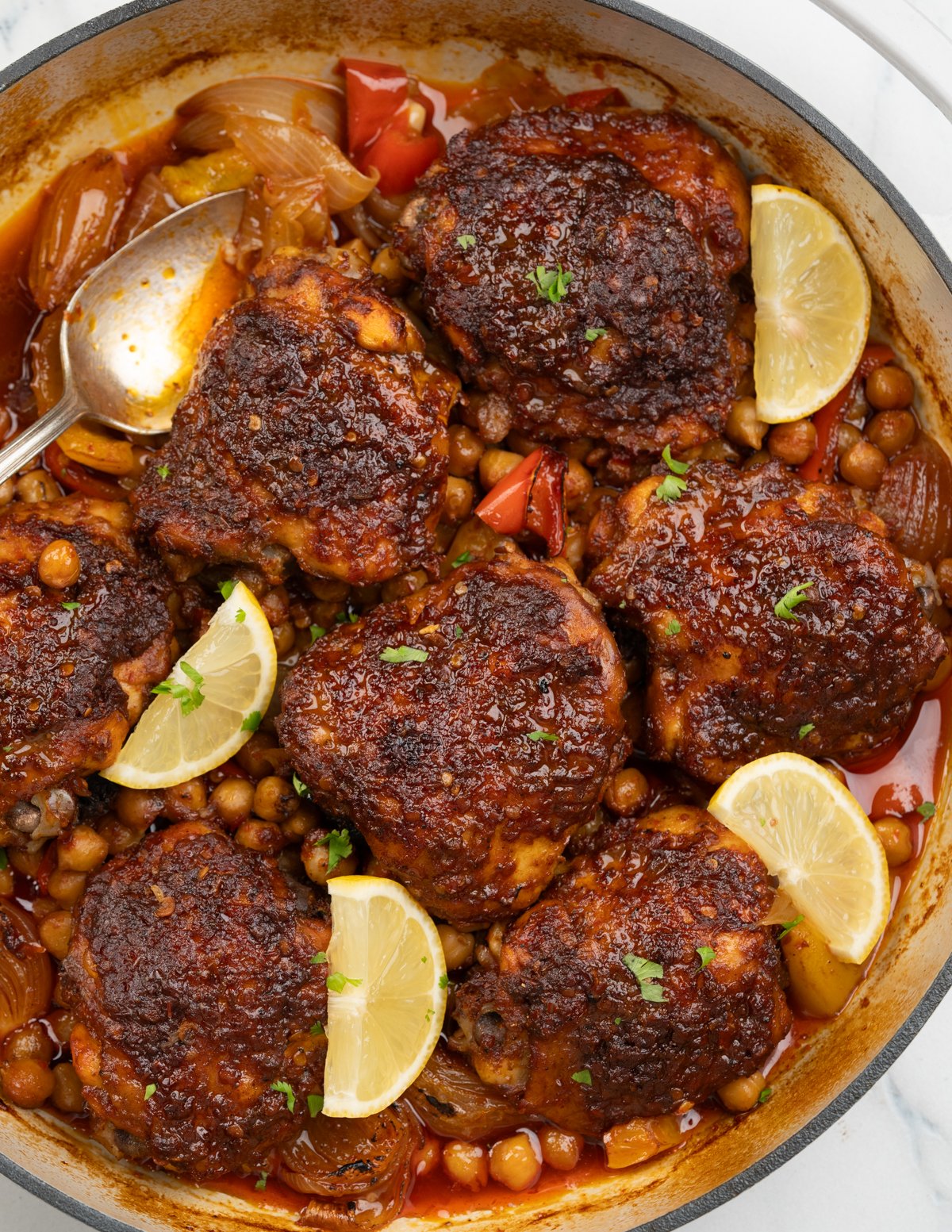 Baked Harissa chicken thighs with chickpeas, onion and pepeprs