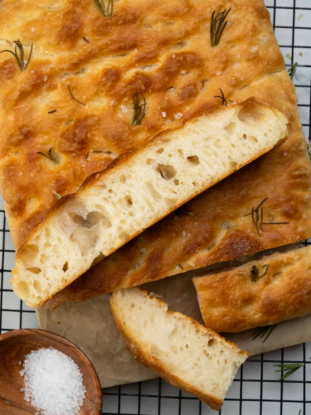 Soft and airy focaccia bread slices with big bubbles. 