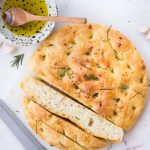 No-knead focaccia bread flavoured with roasted garlic and rosemary. A must-try bread if you are looking for fuss-free, easy, no-knead bread. You can also add olives, sundried tomato and other toppings to it.