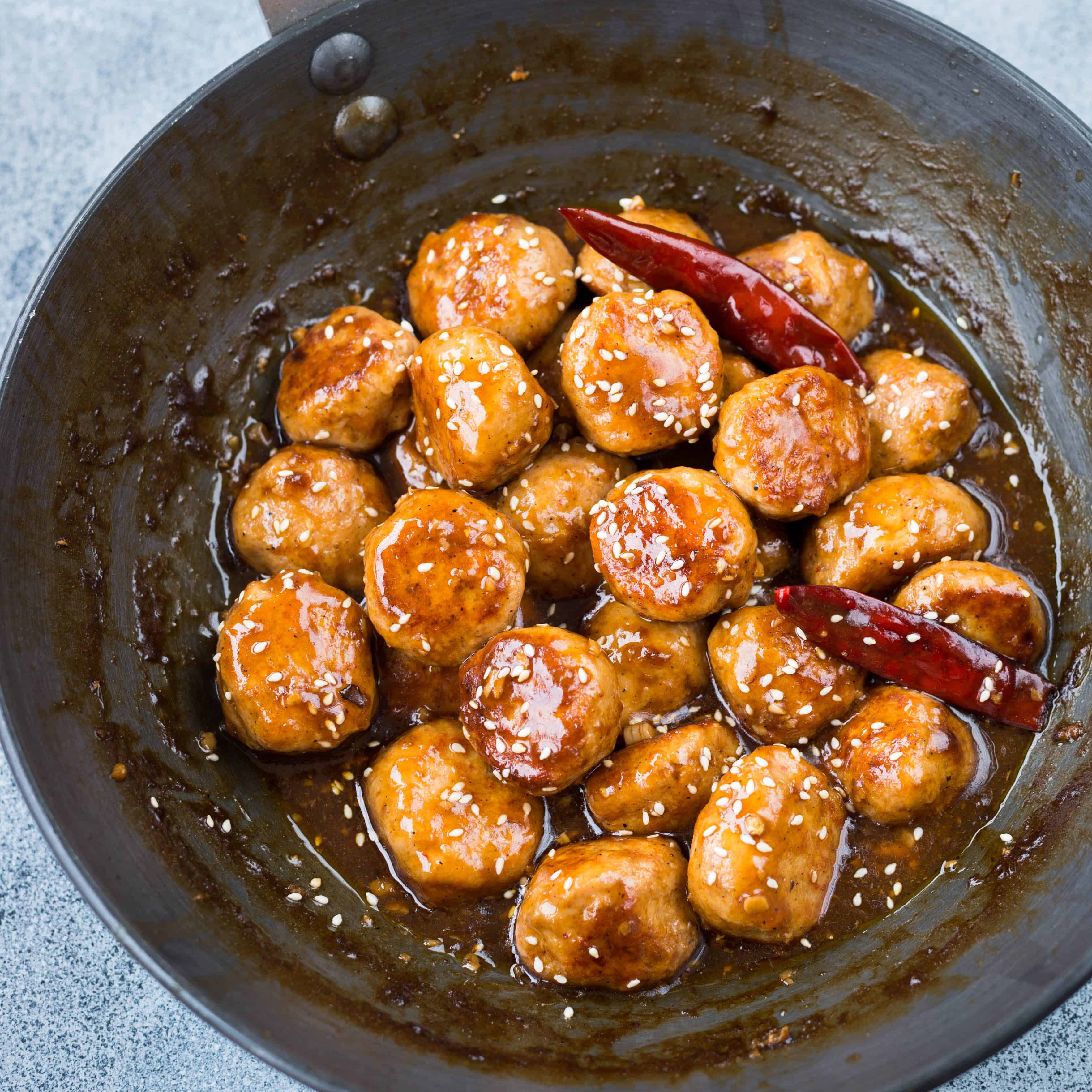Picture of Juicy chicken meatballs made with zingy asian sauce made in a skillet