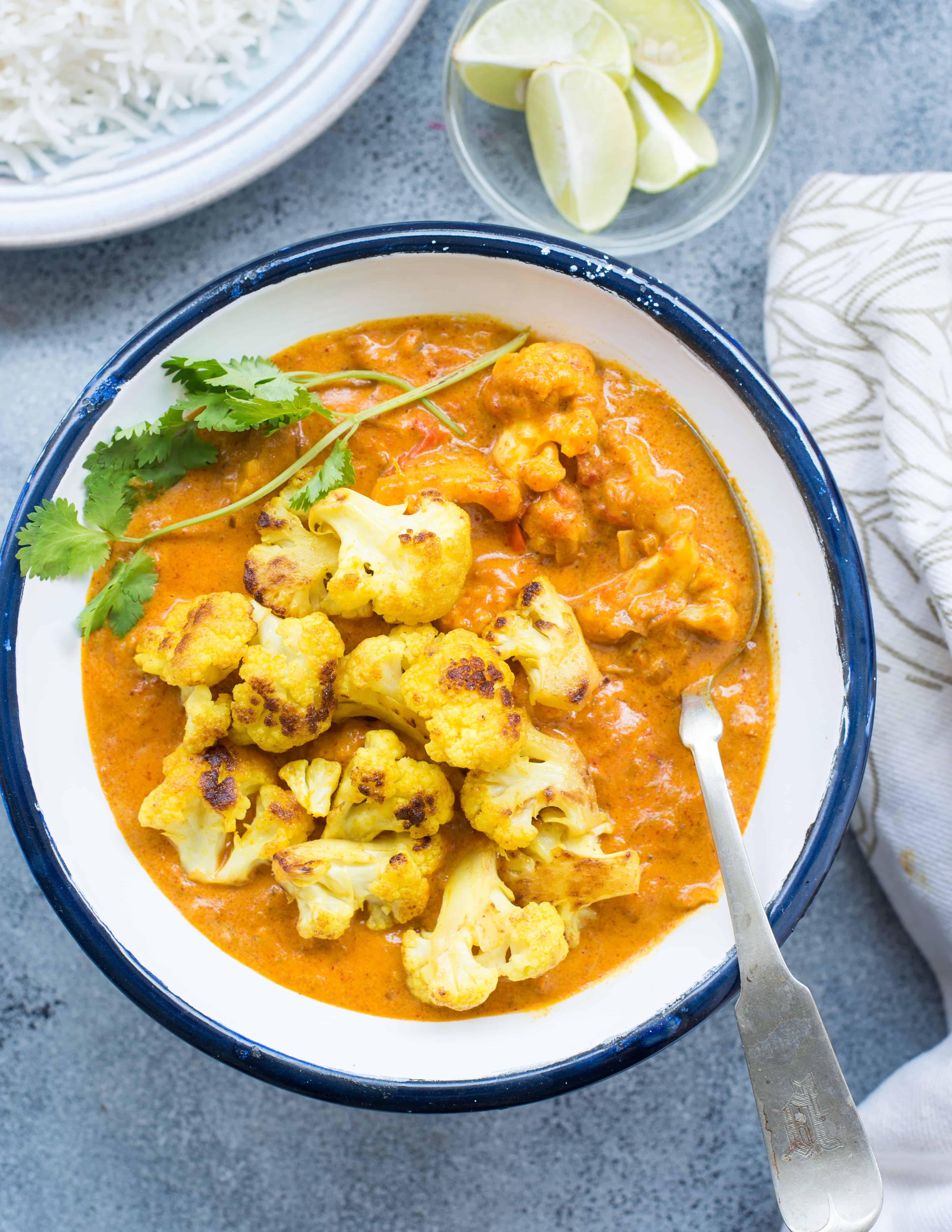 Cauliflower recipe made with coconut milk is served in a white bowl