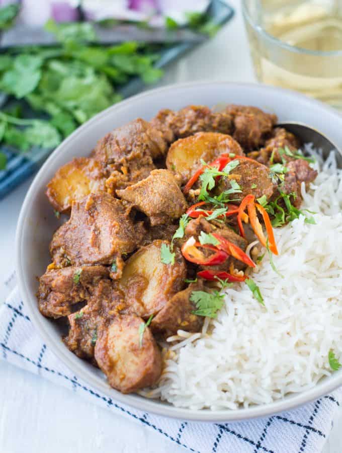 Lamb and potatoes cooked slowly in onion tomato gravy and Indian Spices. This basic Indian Mutton Curry with juicy tender pieces of Mutton is perfect for a leisurely Sunday family meal.  