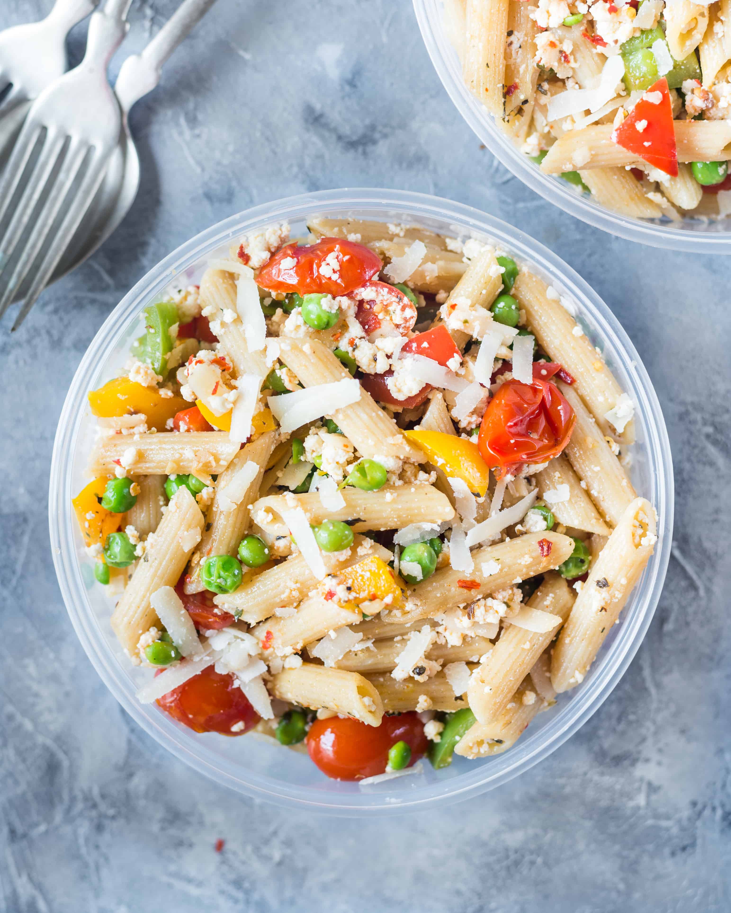 Vibrant and colorful, cold pasta salad made with soft ricotta cheese is served in a bowl.