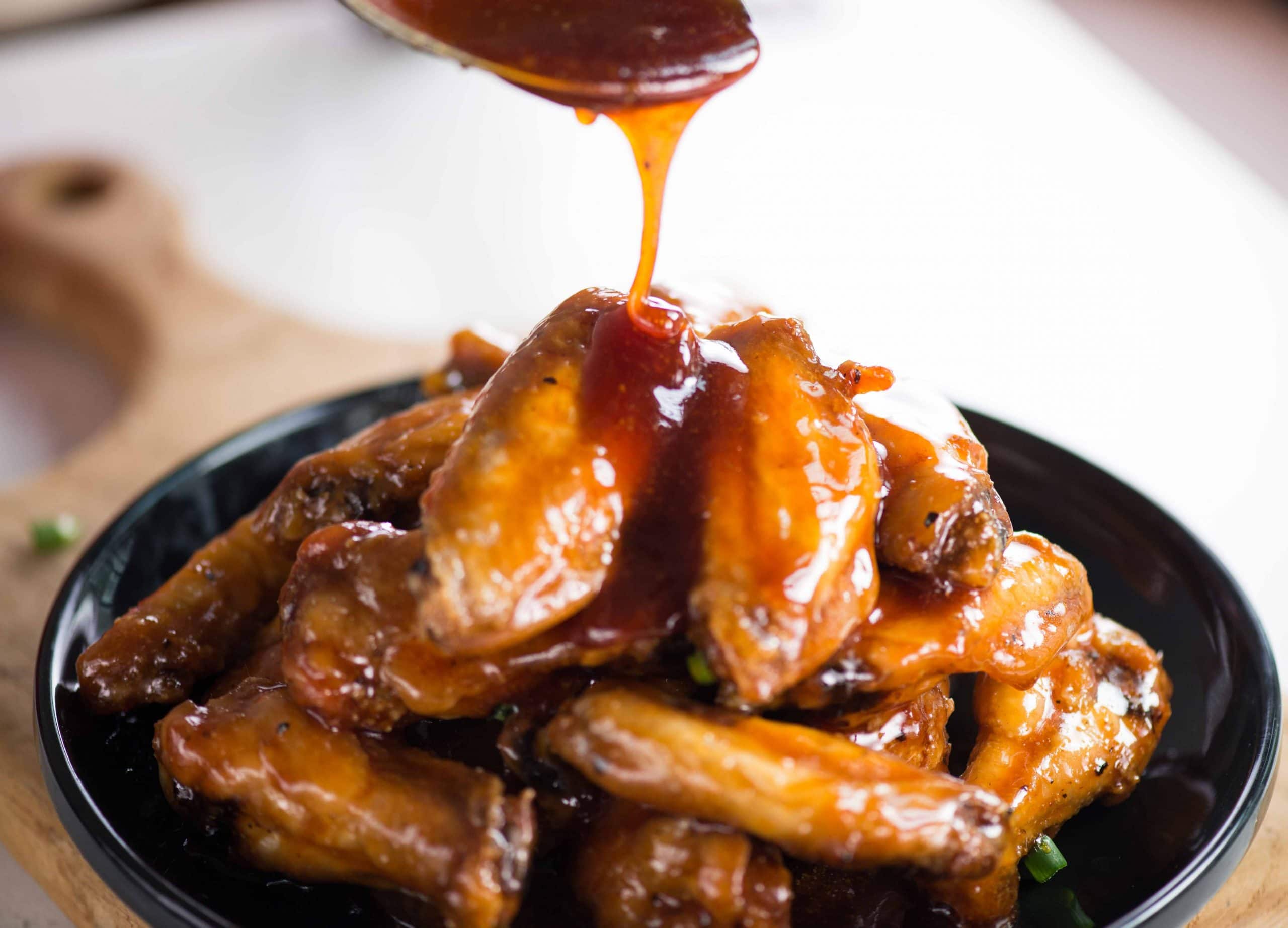 Crispy baked chicken wings are tossed in a sweet, sour and sticky sauce. These chicken wings are addictive and perfect party appetizer. 