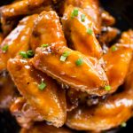 Crispy baked chicken wings are tossed in a sweet, sour and sticky sauce. These chicken wings are addictive and perfect party appetizer. 
