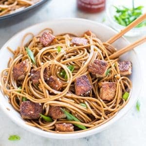 Crispy Sesame Ginger Tofu with Soba Noodles served in a bowl with chopsticks