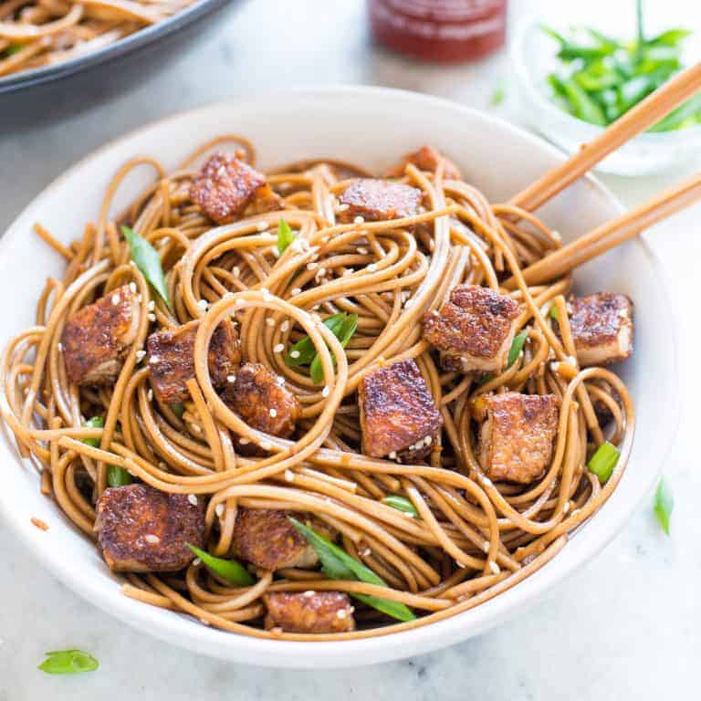 Crispy Sesame Ginger Tofu with Soba Noodles served in a bowl with chopsticks