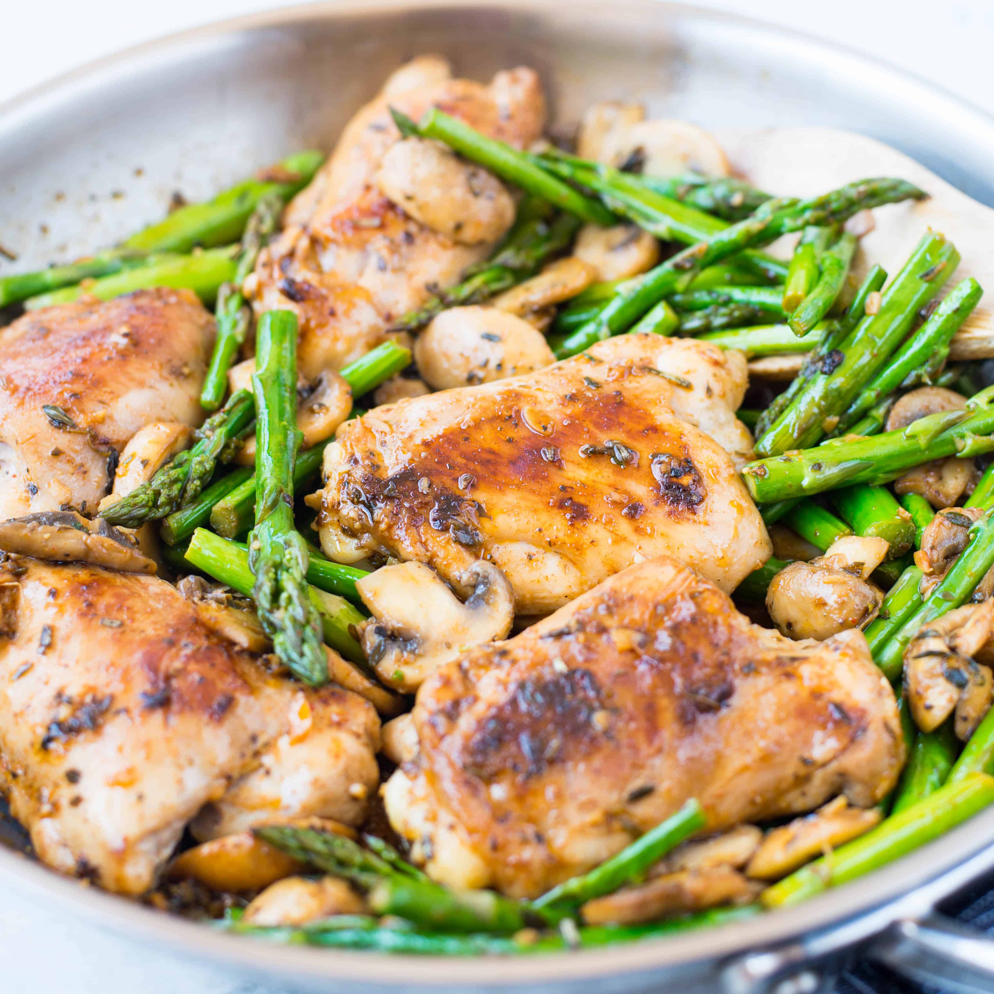 Close up view of Chicken, asparagus and mushroom cooked with a lemony buttery herb sauce