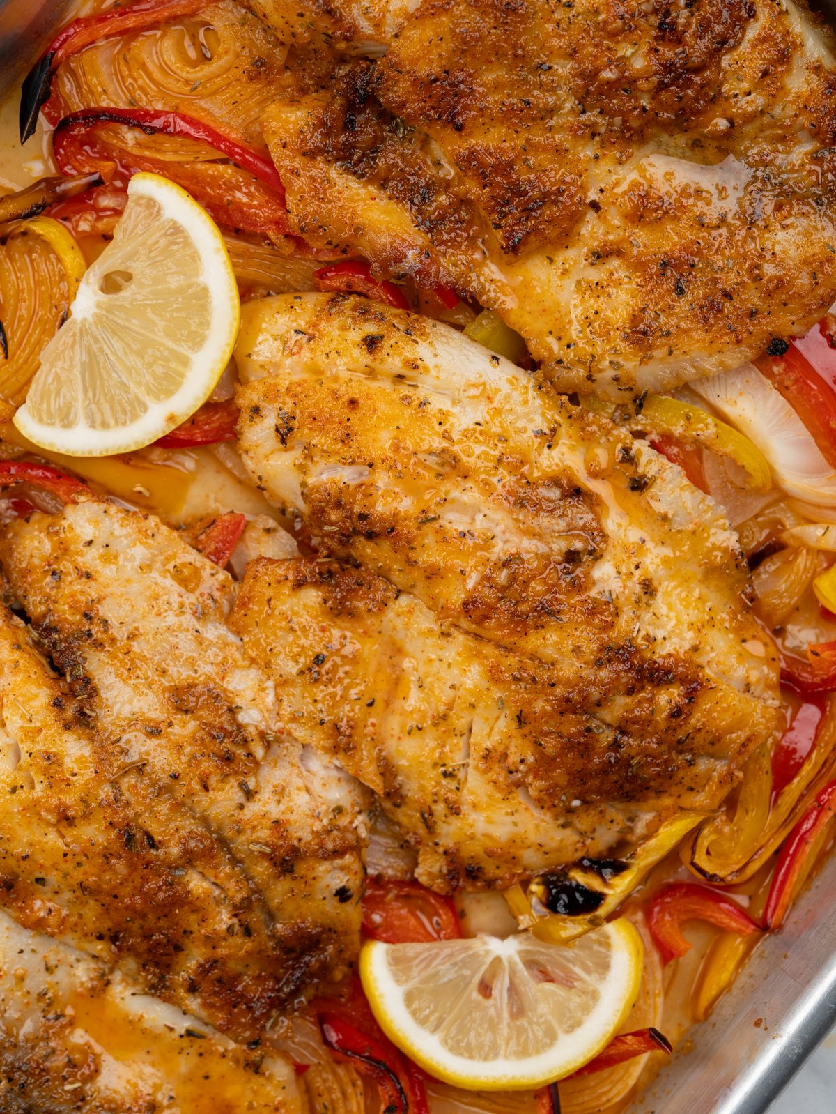 Tilapia in bed of onion, peppers baked in a delicious lemon butter sauce.