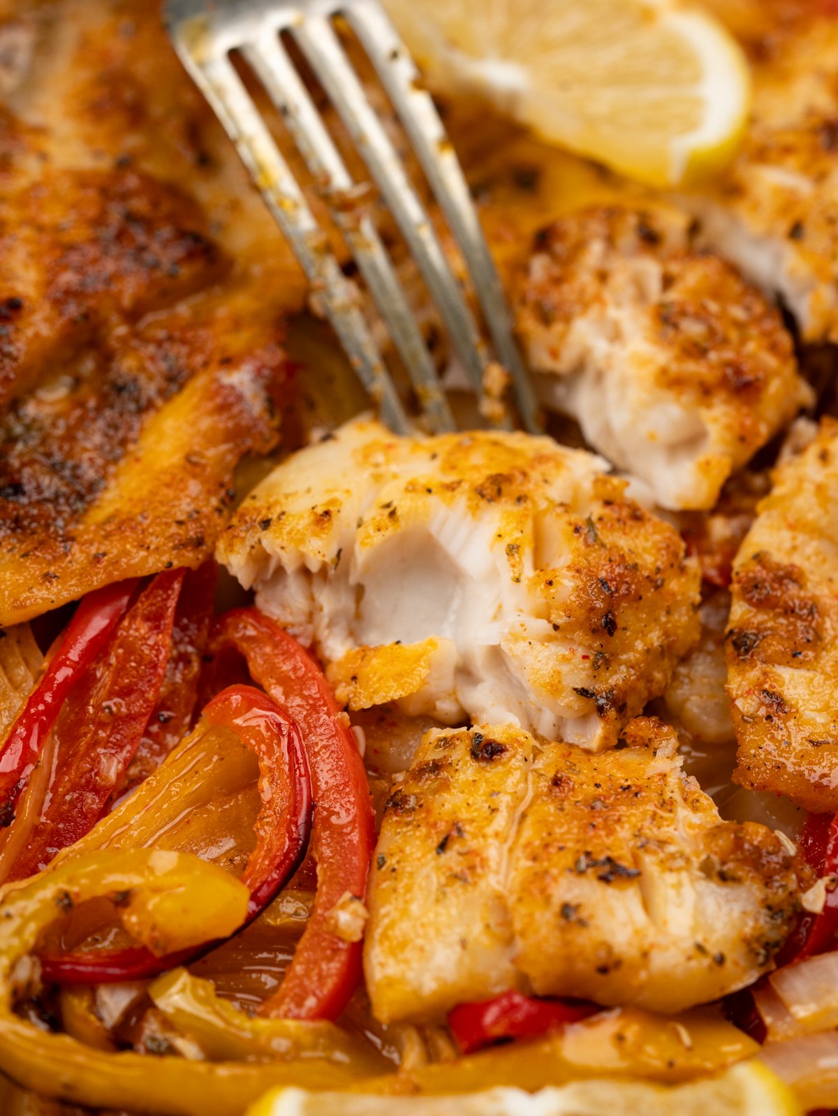 flakey tender Tilapia in bed of onion, peppers baked in a delicious lemon butter sauce.