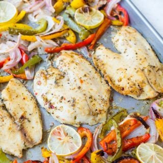 Baked Tilapia with onion and pepper in a delicious lemon garlic butter sauce. This Sheet Pan Lemon Garlic Baked Tilapia and Veggies is a healthy dinner made in under 20 minutes.