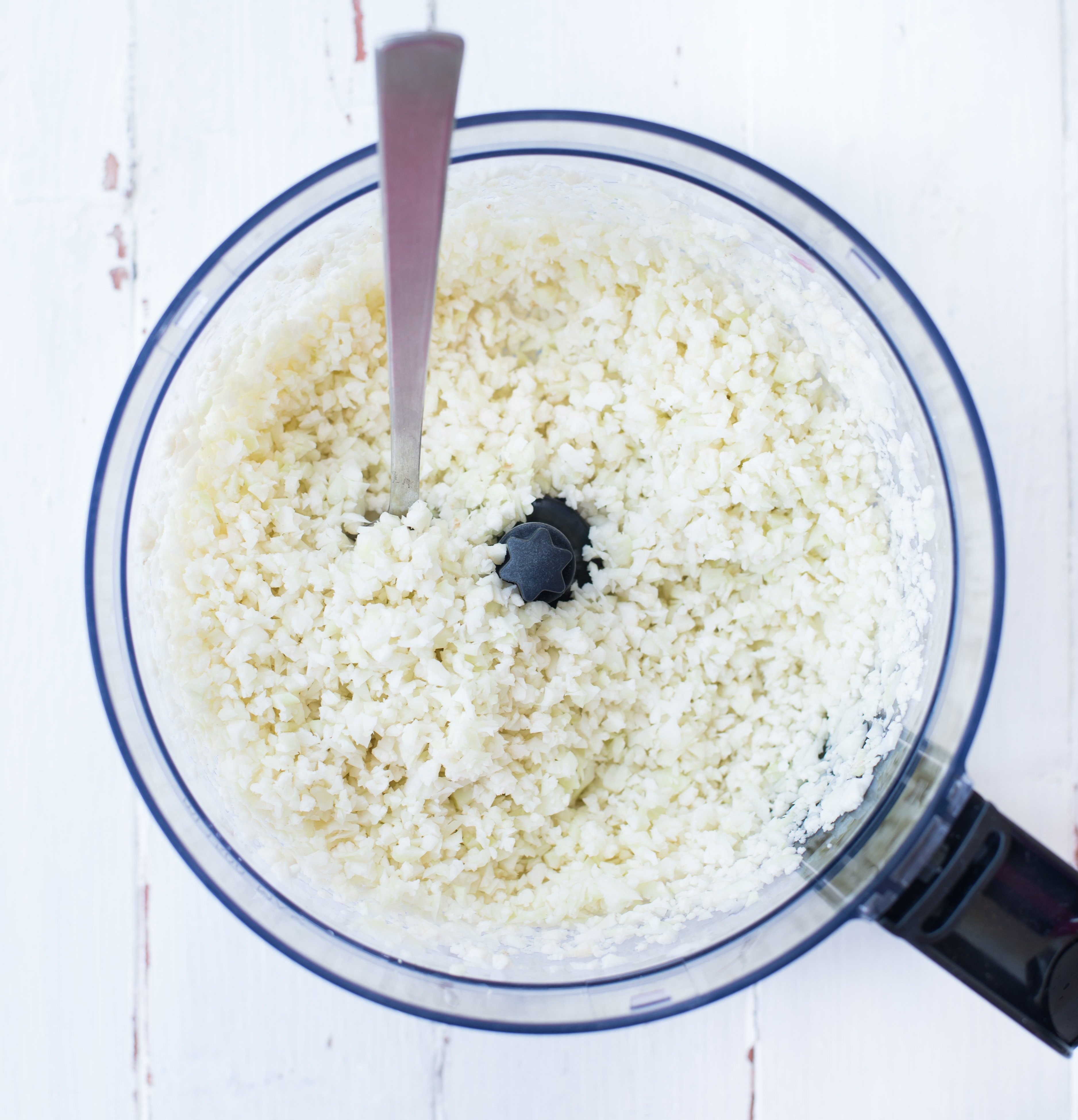 Cauliflower florets made into rice like texture in a food processor.