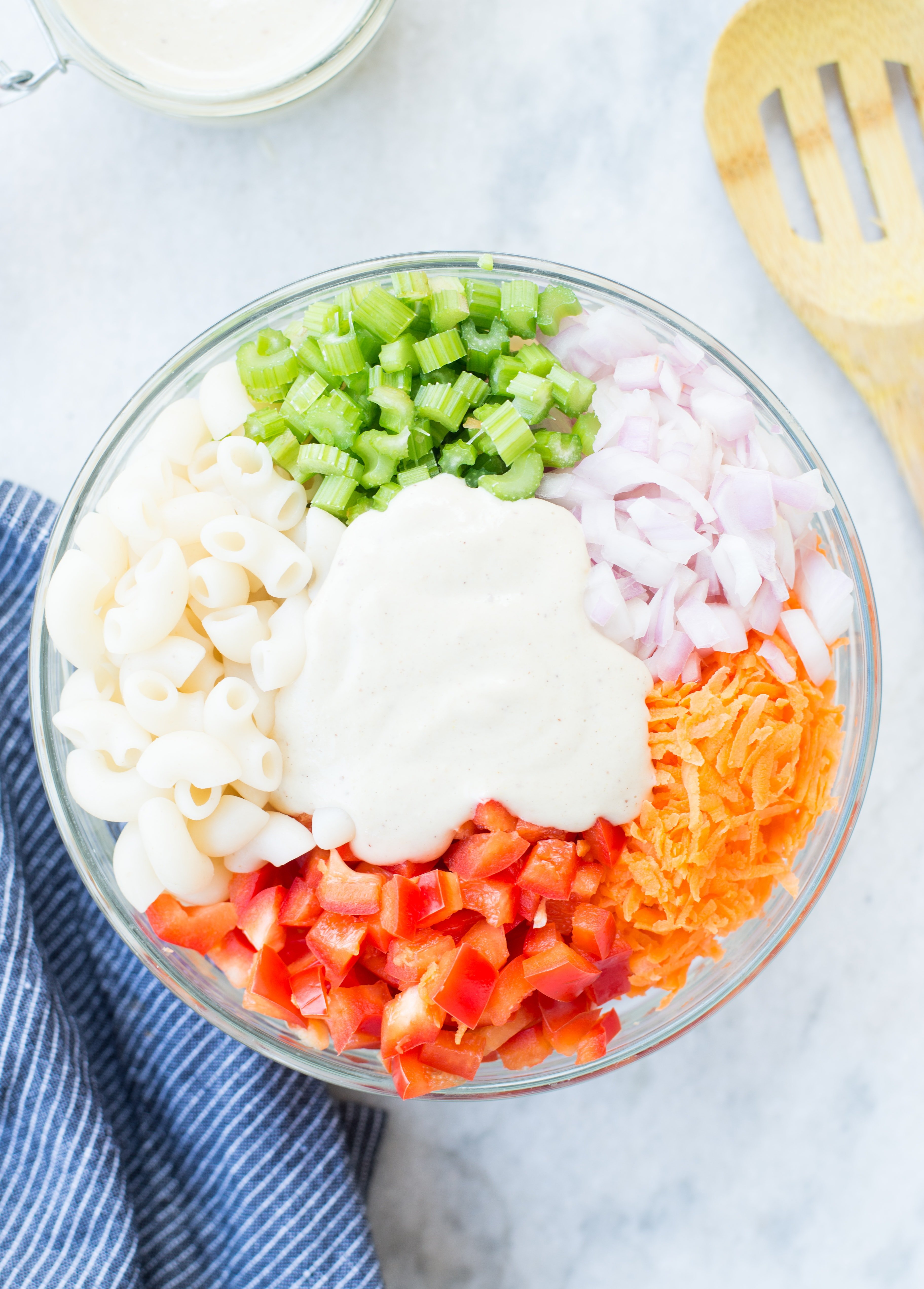 Delicious Vegan Macaroni Salad is a perfect side for Picnic, potluck or Barbecue. This Vegan Pasta salad is creamy with crisp vegetables and a light Tahini Cashew Dressing.