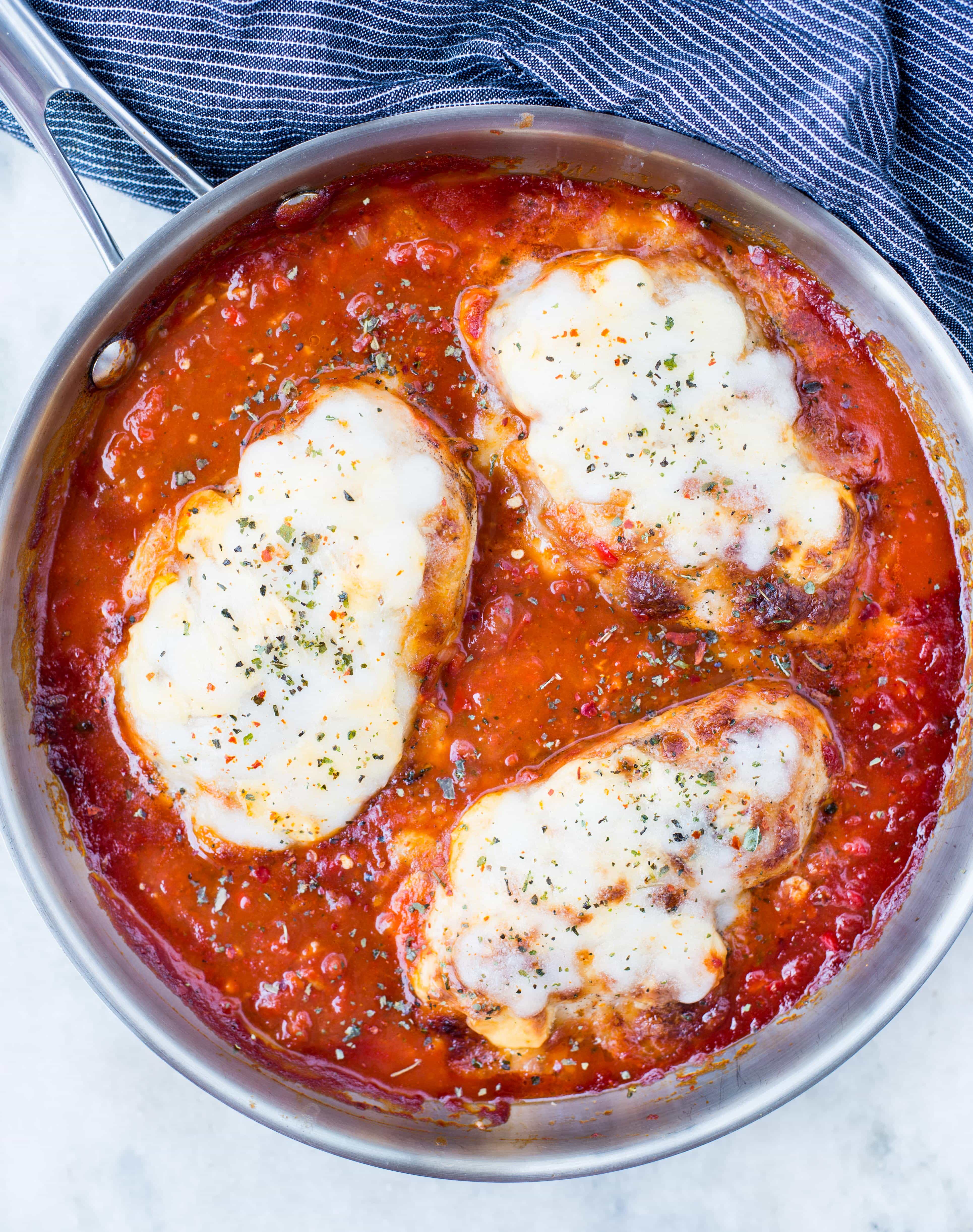 This Easy Mozzarella Chicken in homemade tomato sauce is low carb and made in one skillet. Pan Seared Chicken cooked in chunky tomato sauce and topped with gooey mozzarella is a perfect low carb dinner.