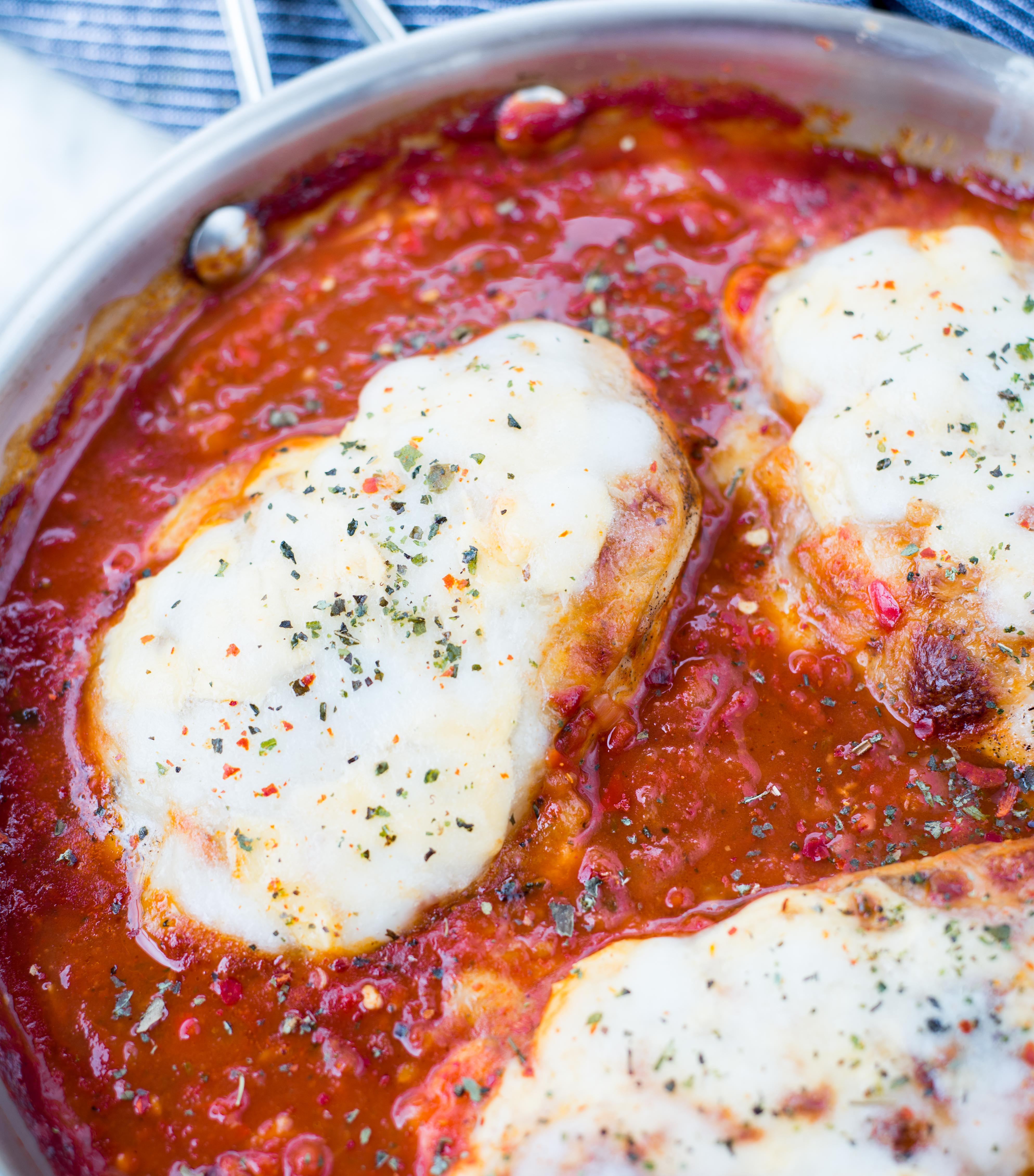 This Easy Mozzarella Chicken in homemade tomato sauce is low carb and made in one skillet. Pan Seared Chicken cooked in chunky tomato sauce and topped with gooey mozzarella is a perfect low carb dinner.