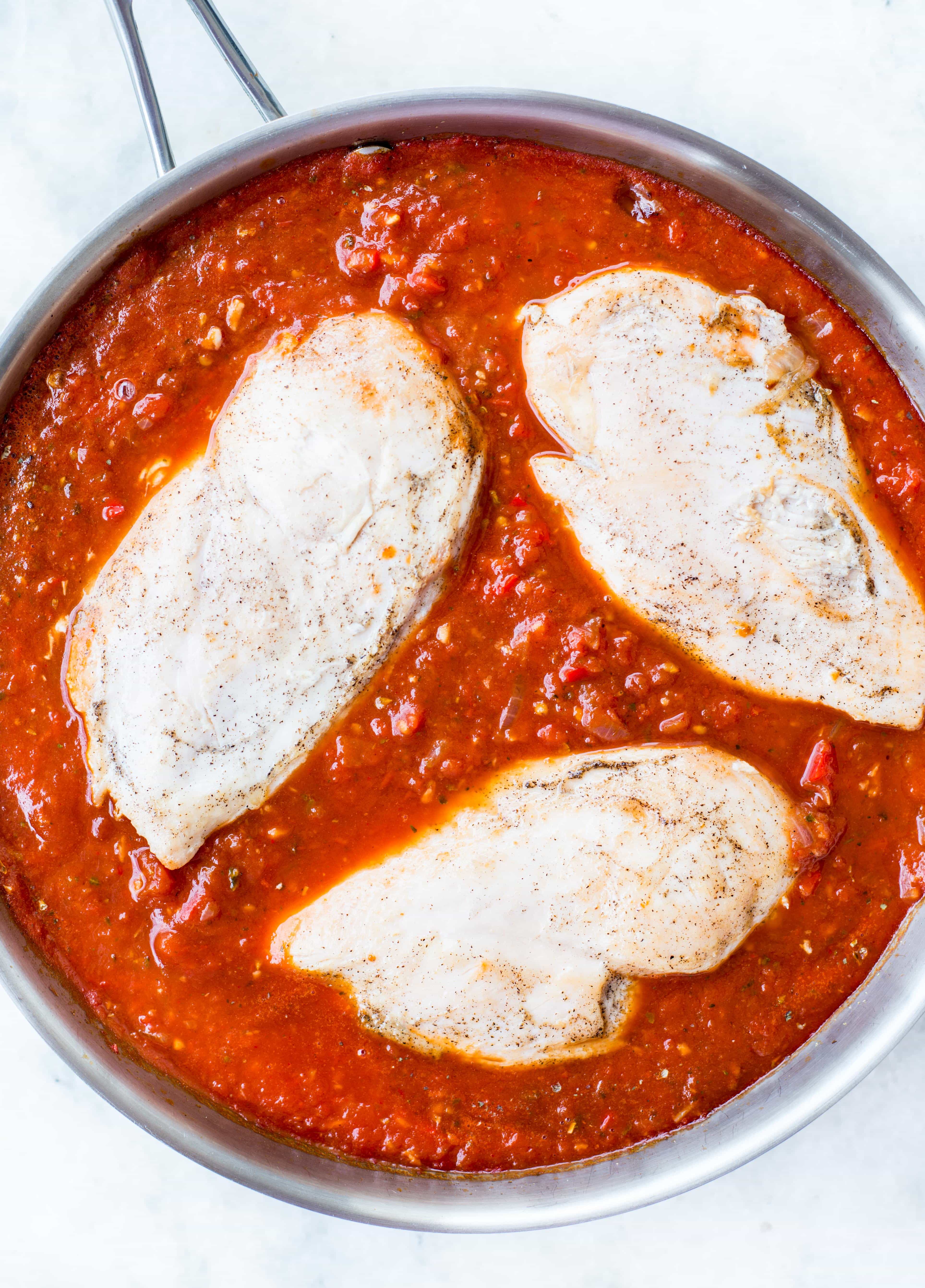 This Easy Mozzarella Chicken in homemade tomato sauce is low carb and made in one skillet. Pan Seared Chicken cooked in chunky tomato sauce and topped with gooey mozzarella is a perfect low carb dinner.