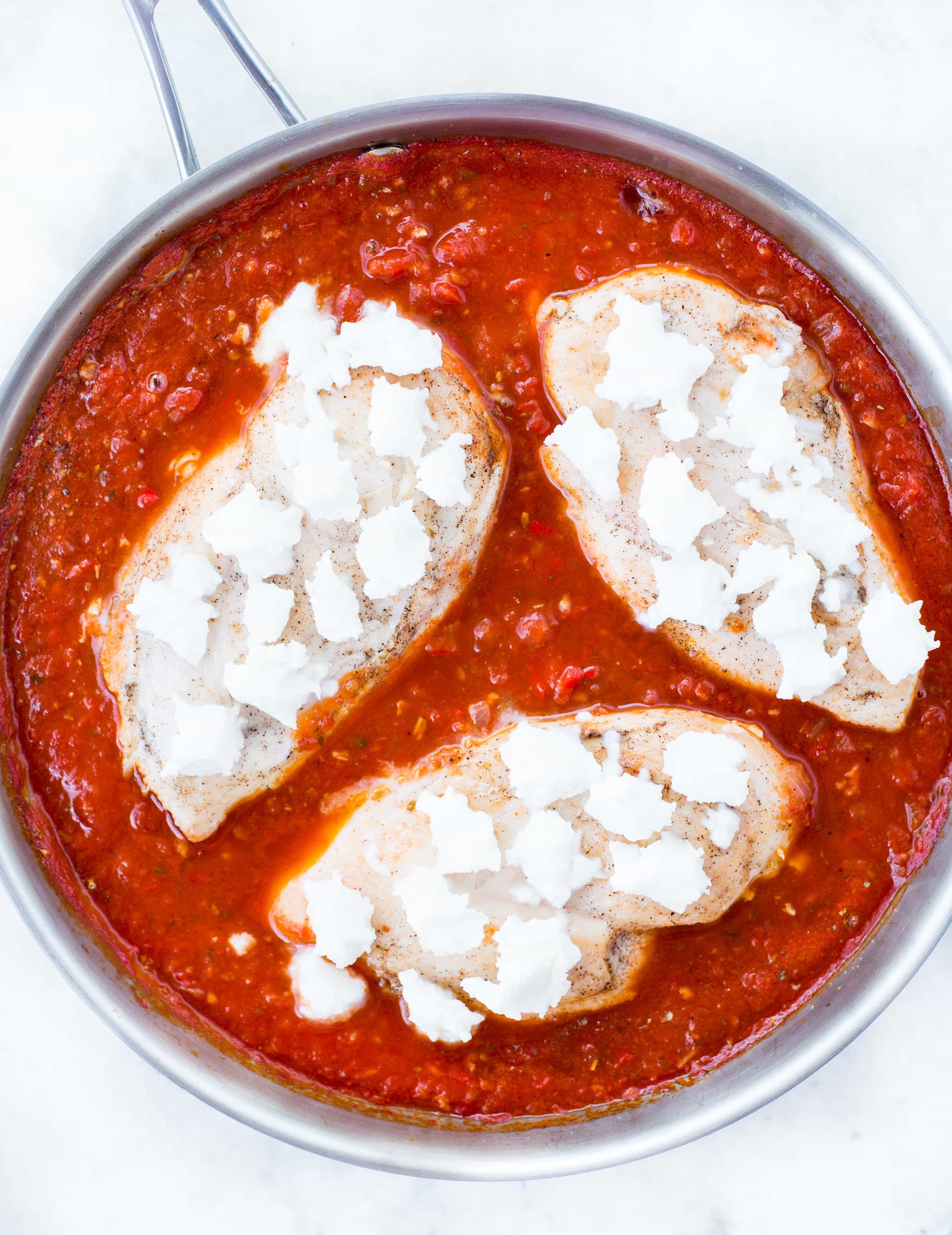 This Easy Mozzarella Chicken in homemade tomato sauce is low carb and made in one skillet. Pan Seared Chicken cooked in chunky tomato sauce and topped with gooey mozzarella is a perfect low carb dinner.