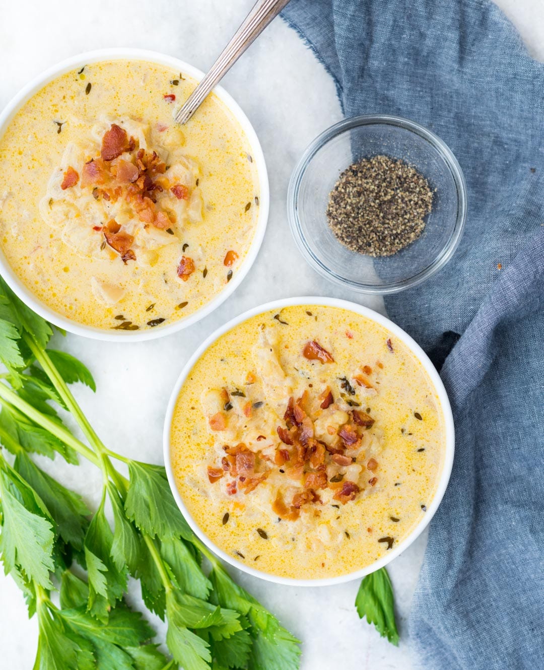 Bowl of. Low Carb keto-friendly Cauliflower Soup with bacon and herbs.
