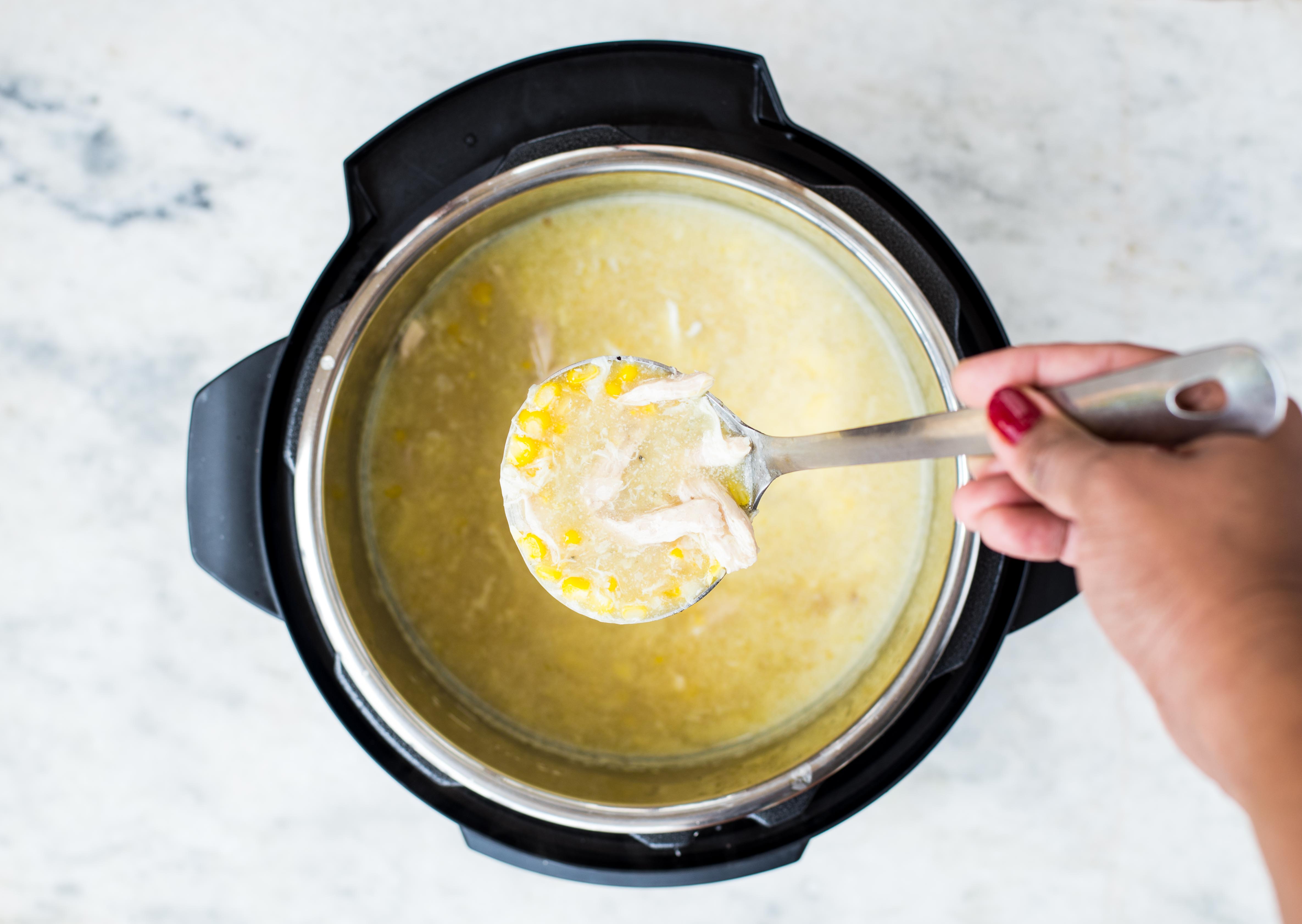 Thick and creamy corn chicken soup picked with a laddle from the Instant Pot.