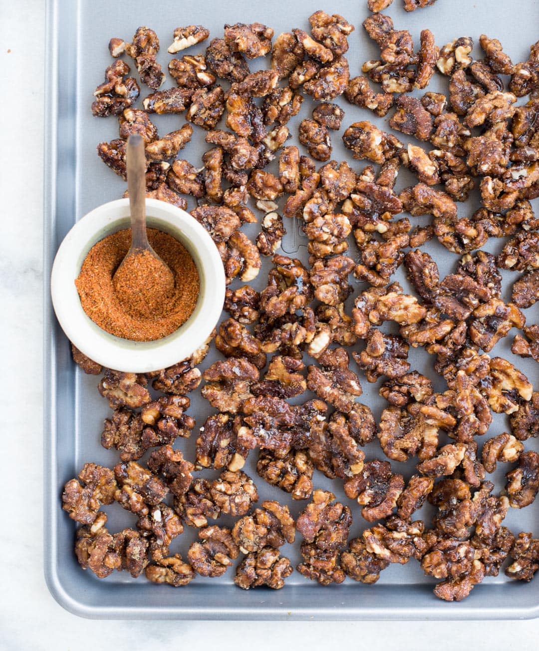 These Candied walnuts are roasted with honey and spices till crunchy, then tossed in brown sugar. Honey Spiced Candied Walnuts are addictive snacks, can be added to salads and perfect for gifting this holiday season.