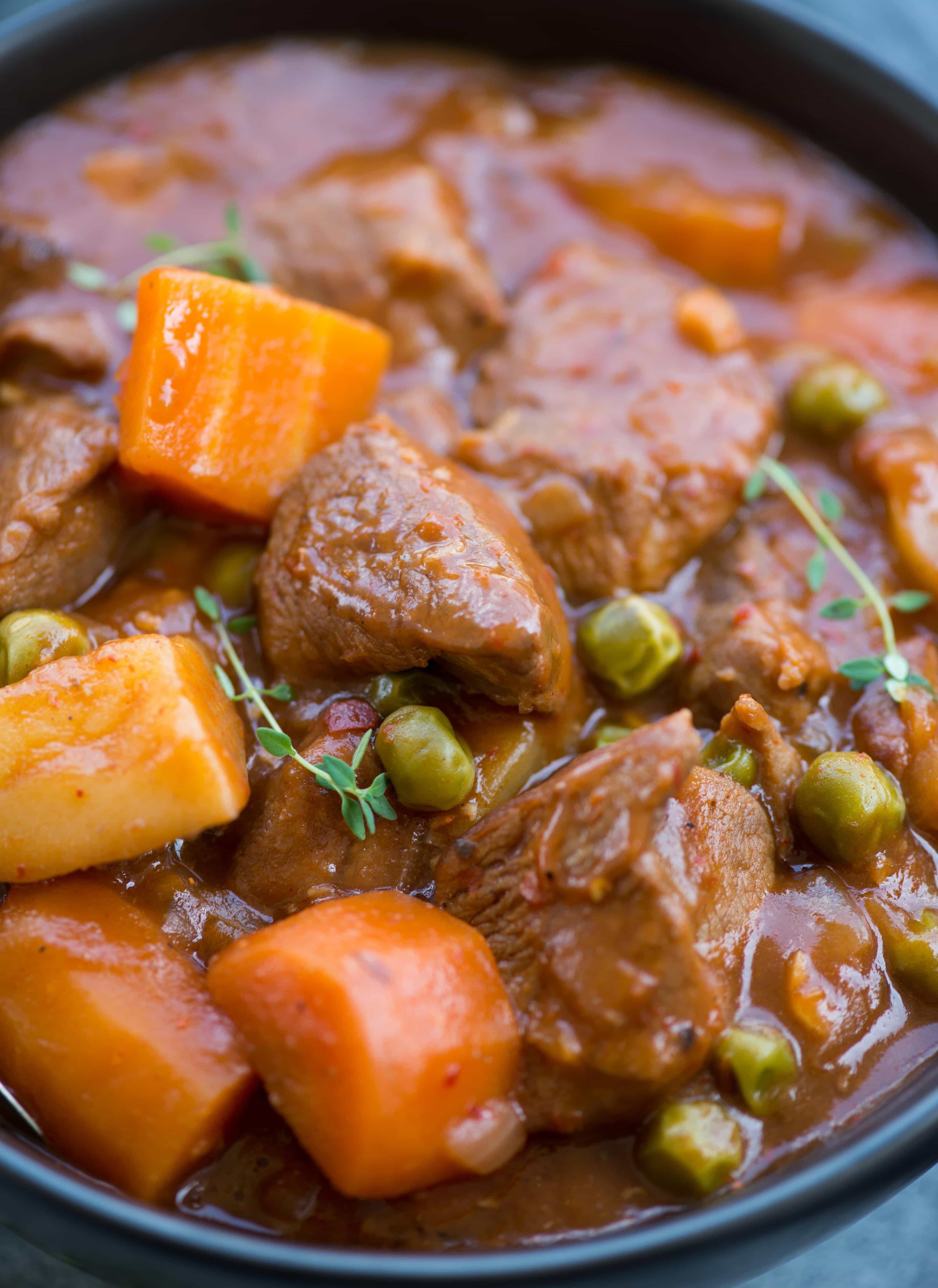 Close-up shot of Lamb Stew with tender fall apart lamb chunks and vegetables in a rustic flavourful wine based gravy. 