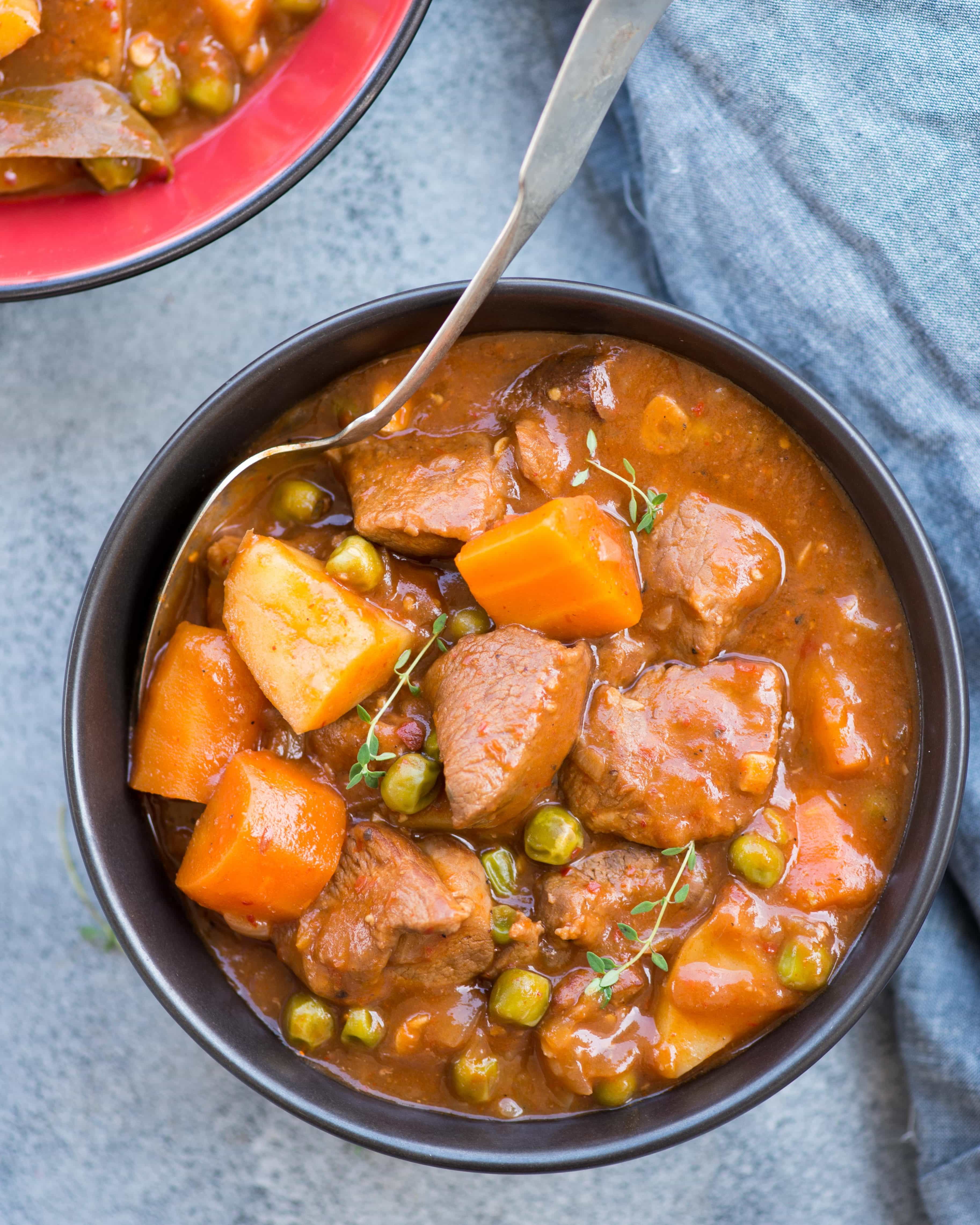 Slow Cooker Lamb Stew with tender fall apart lamb chunks and hearty vegetables have a rustic flavourful wine based gravy. This Lamb Stew is definitely going to keep you warm in the winter.