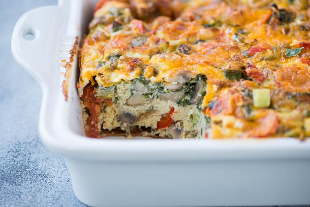 Easy breakfast casserole with bread loaded vegetables, egg, bread and topped with cheese. This Breakfast Casserole recipe can be made ahead and perfect to feed a big crowd.