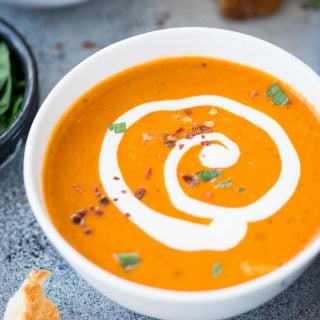 Thick and Creamy Tomato Bisque with a hint of tartness from the tomatoes, is the perfect soup for cold winter days. It is healthy, gluten-free and easy to make. Serve this with a big slice of crusty garlic cheese toast or grilled cheese.