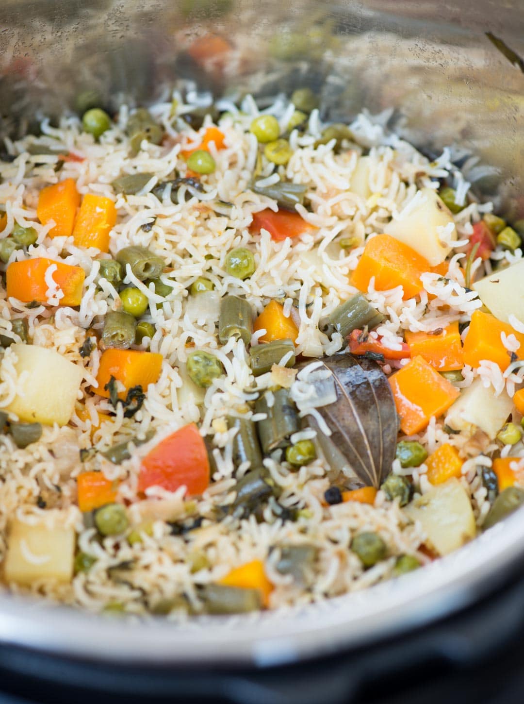 Close up photo of vegetable pulao made with vegetables and whole spices in an Instant pot