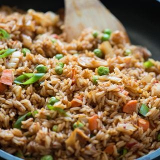 Quick and easy Kimchi Fried rice with tons of flavour from Kimchi, Garlic, ginger and gochujang. Throw in some peas, carrots and top it with sunny side up for a delicious meal.