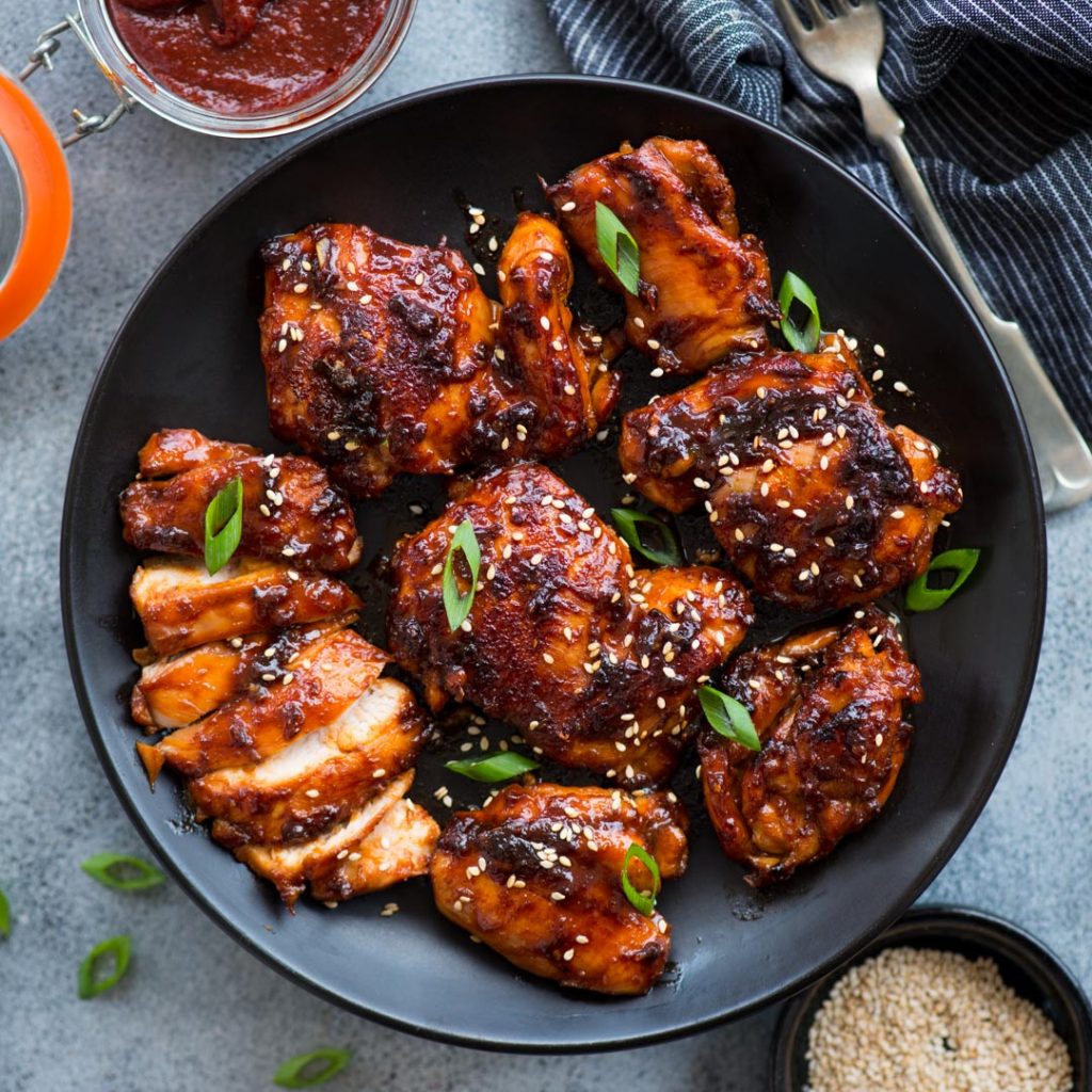 Sticky Korean Chicken made with Gochujang, soy sauce based marinade is bold in flavours and really easy to make. Chicken thighs coated in a sweet and spicy sauce and cooked until juicy.