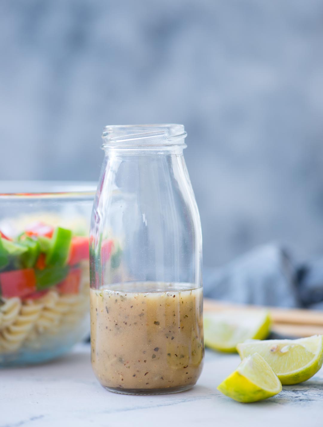Refreshing lemon herb dressing with mediterranean flavors in a bottle, can be stored in the refrigerator