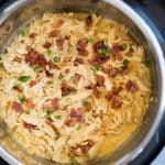 Close-up view of crack chicken made in Instant Pot topped with Instant Pot Crack chicken made with Chicken, Ranch Seasoning, cream cheese, Cheddar cheese and crispy bacon is incredibly delicious. This low carb, Keto chicken takes only 10 minutes to make.