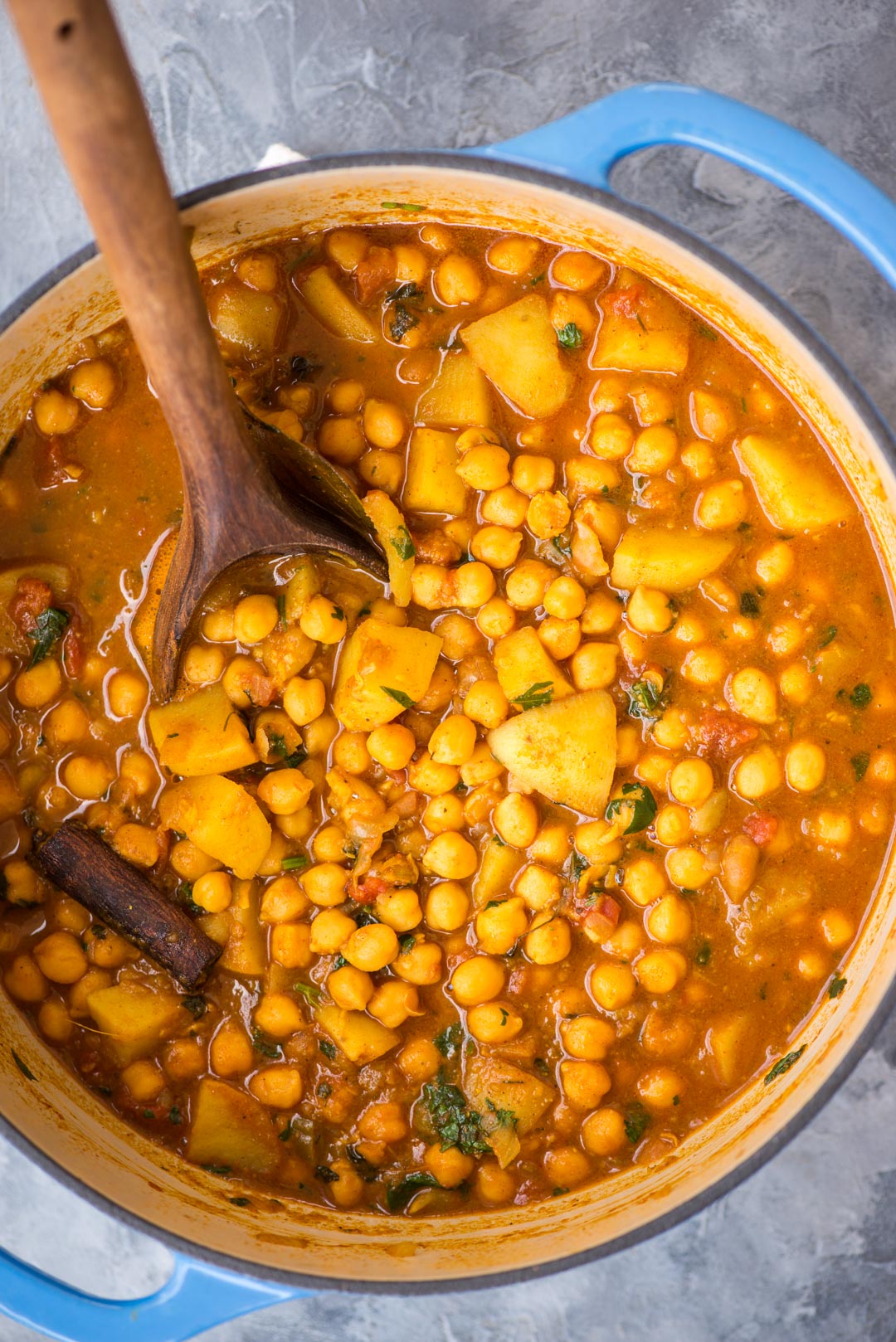 Chickpea curry with potato or Chana Aloo is shown as made in a dutch oven.