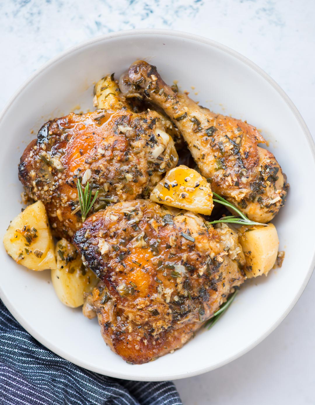 Baked chicken and potatoes in a butter garlic herb sauce, crispy garlic parmesan crusted chicken is a delicious one-pan dinner and very easy to prepare.