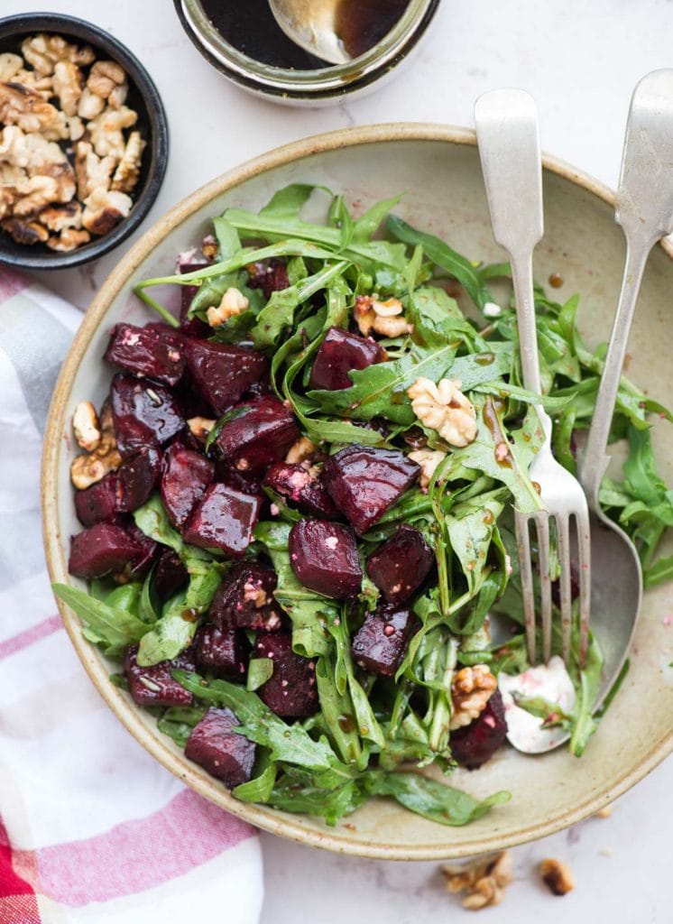 Arugula salad with roasted beetroots, fresh arugula leaves, goat cheese, walnut and a delicious balsamic dressing. It is easy to put together and is a perfect side dish to go with dinner.