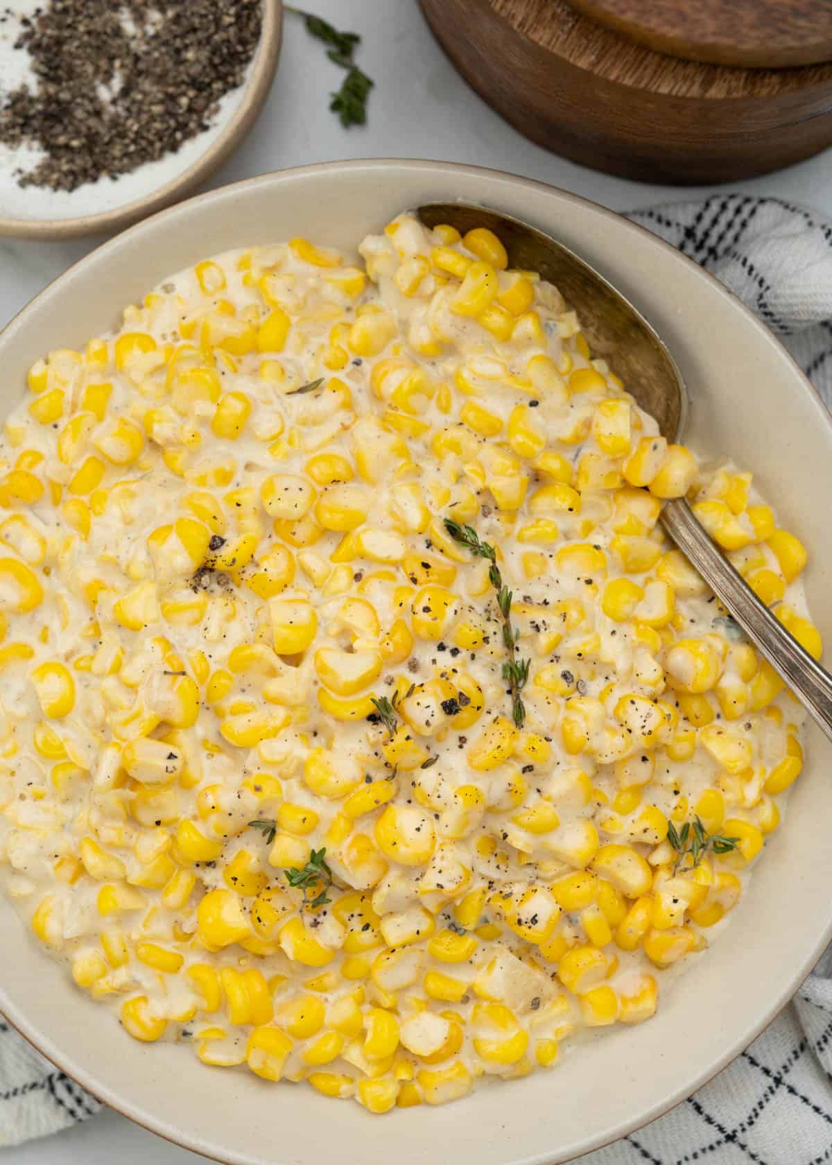 Homemade creamed corn served in a bowl made with fresh/frozen corn, butter, flour. half&half. 