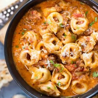 Close view of creamy Sausage Tortellini Soup served in a bowl