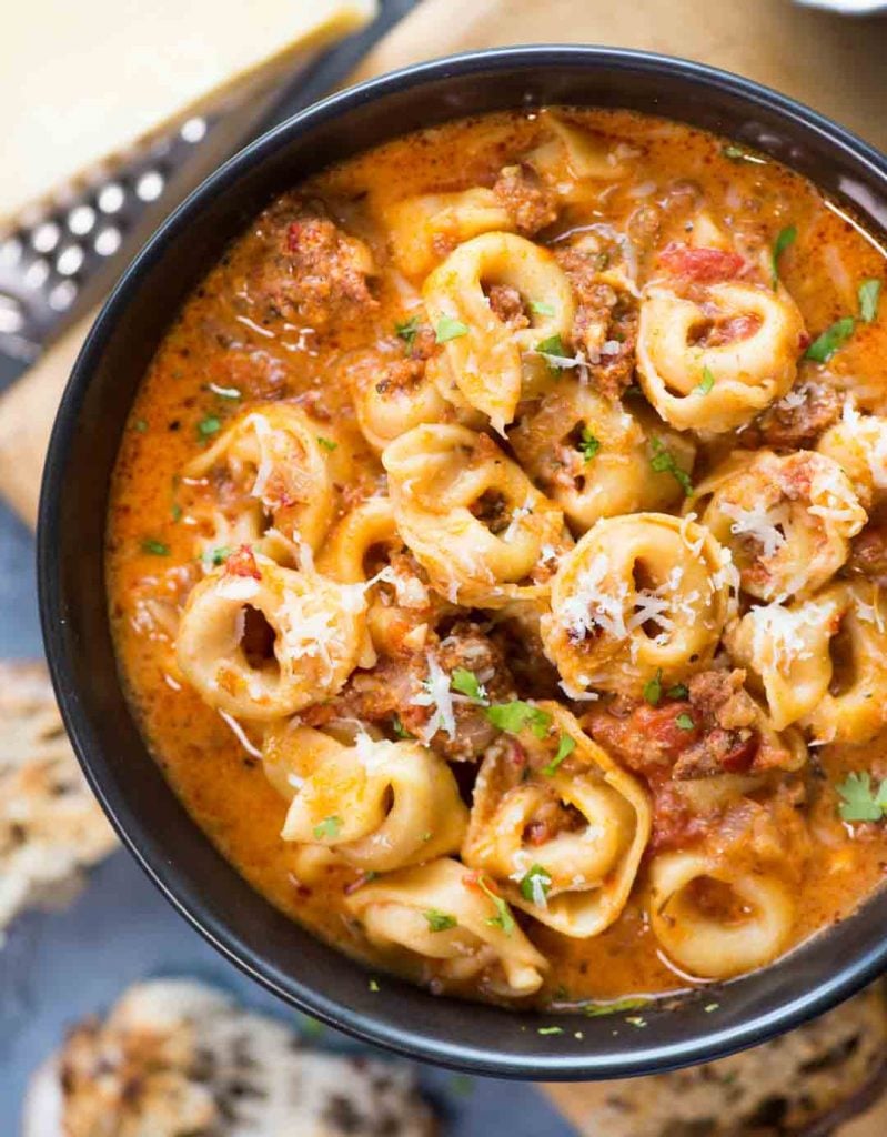 Close view of cheesy Sausage Tortellini Soup served in a bowl