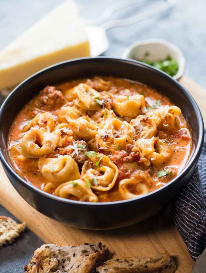 This cosy  Sausage Tortellini Soup is delicious and takes less than 15 minutes to make in an Instant Pot. A bowl of Creamy Tomato based broth, Sausage, Cheesy soft Tortellini and a generous sprinkle of parmesan is filling and flavourful.