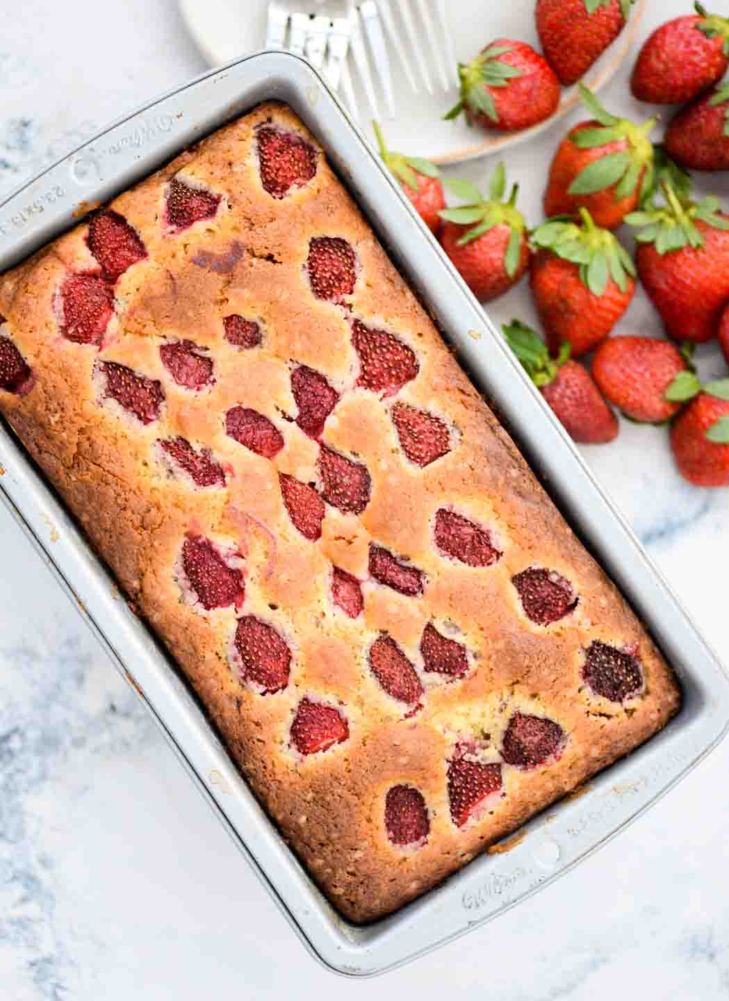 Strawberry Cake with loads of fresh strawberries is made from scratch with basic pantry staples. You will get to taste strawberry in every bite of this buttery, moist and delicious cake.