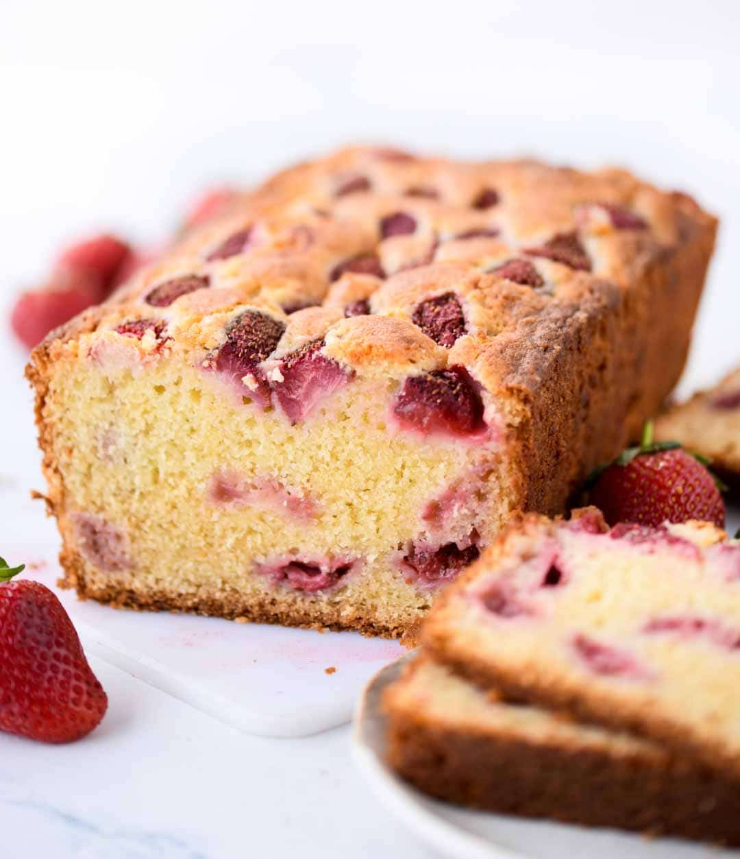 Strawberry Cake with loads of fresh strawberries is made from scratch with basic pantry staples. You will get to taste strawberry in every bite of this buttery, moist and delicious cake.