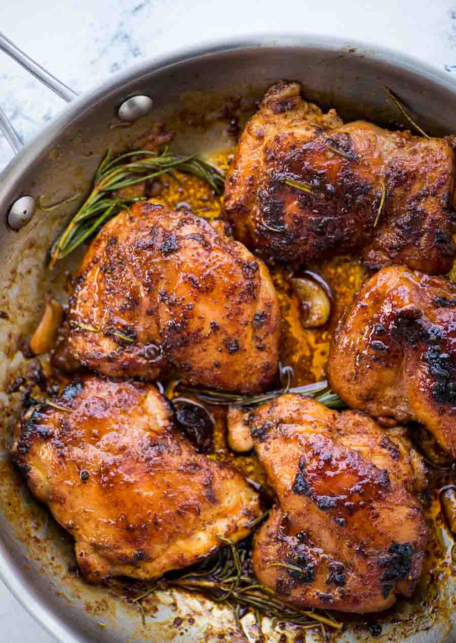 Picture showing a nice golden brown crust on seared boneless chicken thighs in a sweet and spicy sauce.